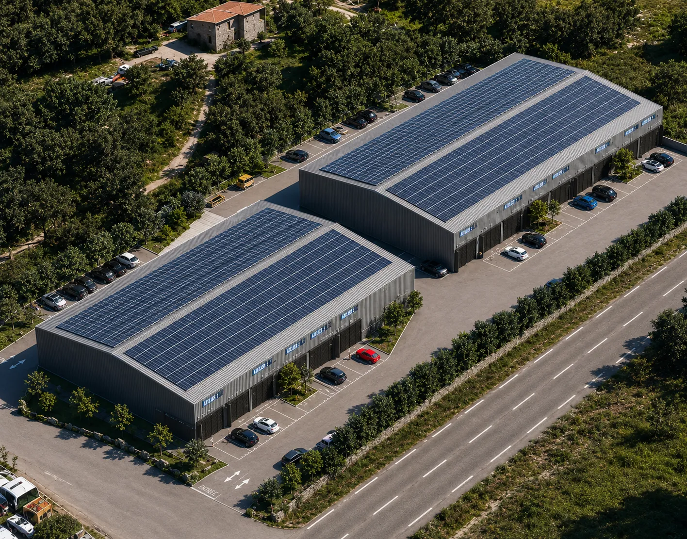 Vue aérienne des deux bâtiments, toitures solaires et parking.